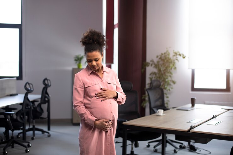 Portrait of young happy pregnant woman standing
