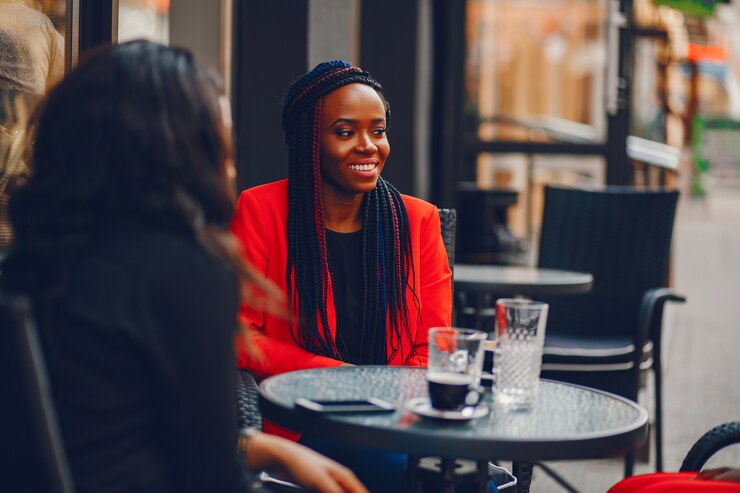 picture showing a young woman outdoors discussing with her friends about her reasons for not living on the island