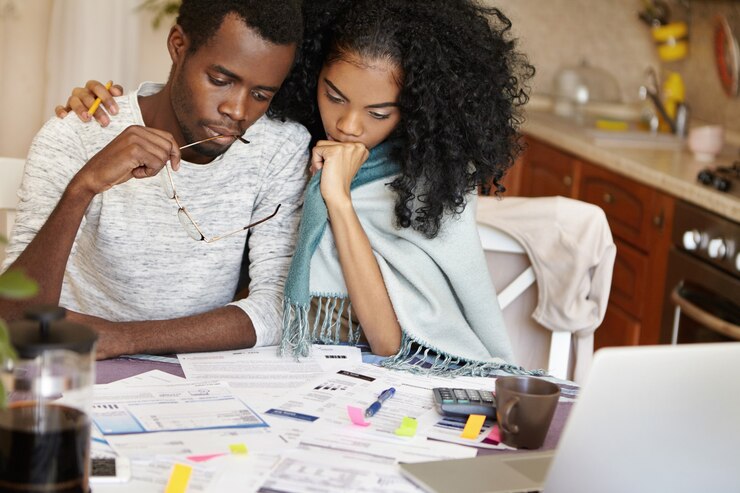 picture showing parents reviewing their expenditure for homeschooling