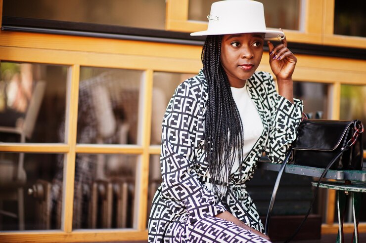 Picture showing a young black woman relaxing and striking a pose for  pictures