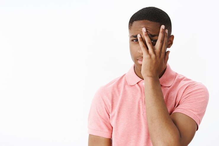 Picture showing man covering his face in embarrassment