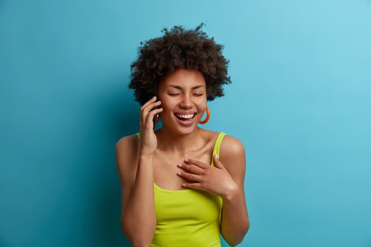 picture showing lady making a call and laughing 