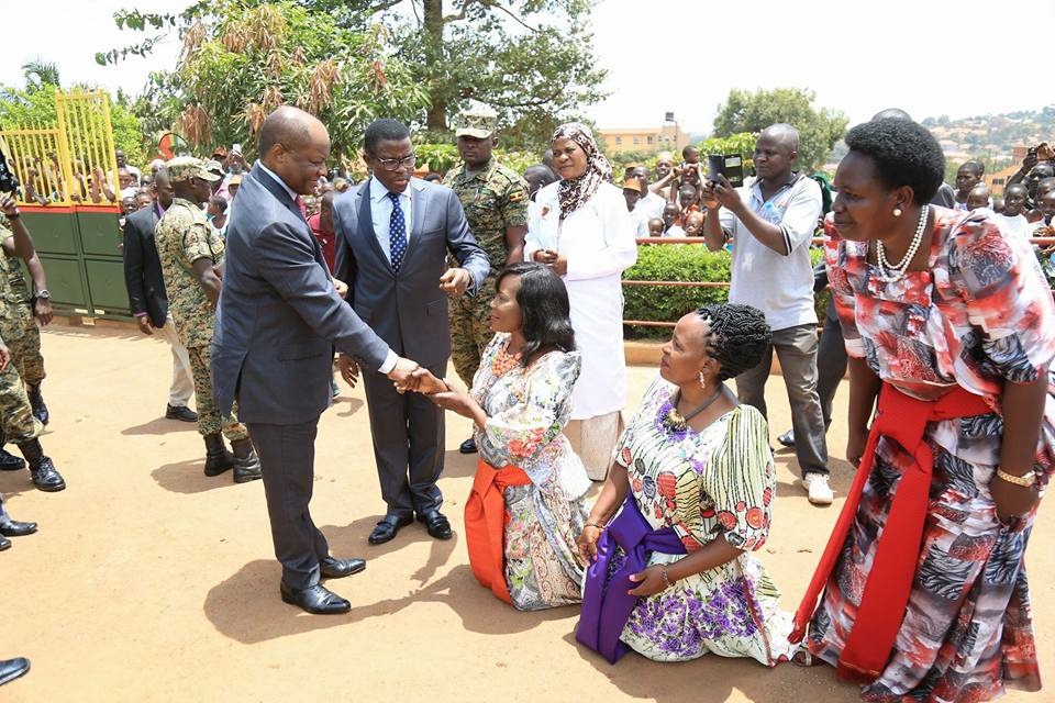 Picture showing women kneeling down to greet their male bosses at work as a result of their childhood trauma