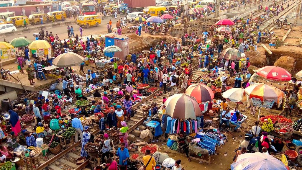 picture showing busy shoppers along the railway line in trying to get home decor in Oshodi Market