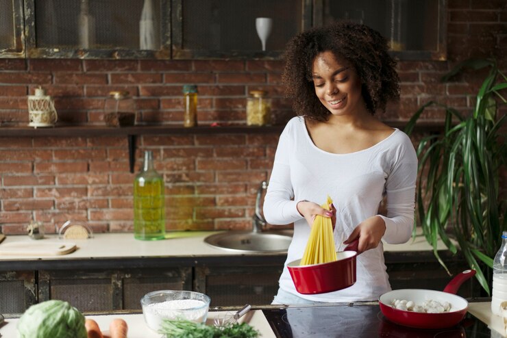 picture showing a woman cooking pasta as new year resolution