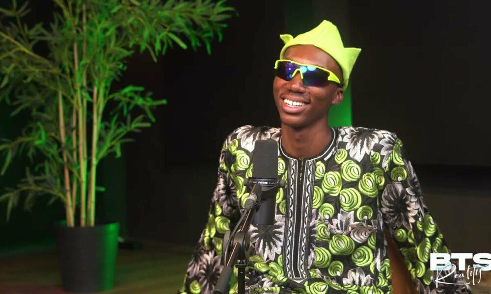 picture showing Nigerian content creator, Layi Wasabi, wearing shades indoors to make a fashion statement