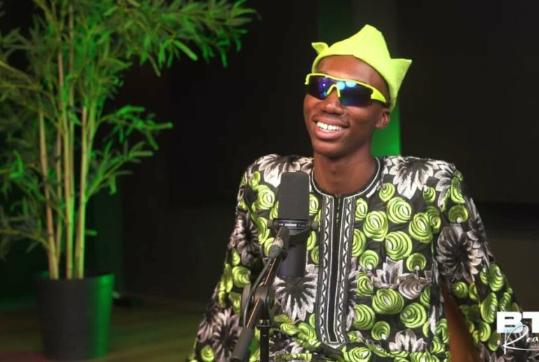 picture showing a Nigerian content creator, Layi Wasabi, wearing shades indoors to make a fashion statement